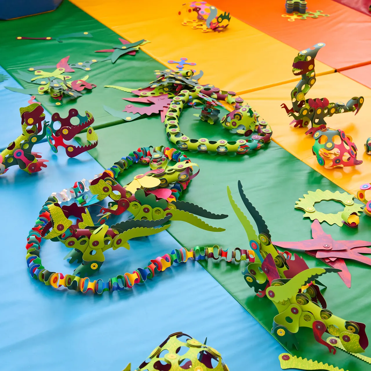Clixo creatures built by a group of children on a colourful play mat